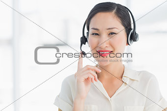 Beautiful smiling female executive with headset