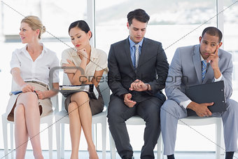 Four business people waiting for job interview