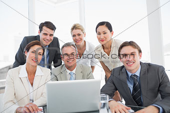 Business colleagues with laptop at office desk