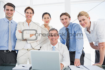 Business colleagues with laptop at desk