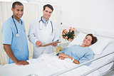 Doctor and surgeon visiting patient in hospital