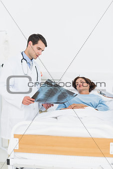 Doctor showing xray to female patient
