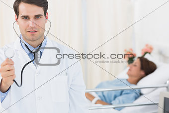 Handsome doctor with patient in hospital