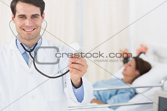 Handsome doctor with patient in hospital