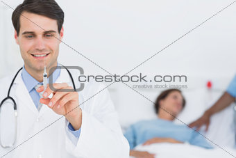 Male doctor holding an injection in the hospital