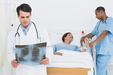 Doctor examining xray with patient in hospital