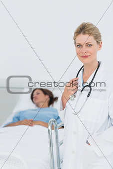 Smiling doctor with patient in hospital