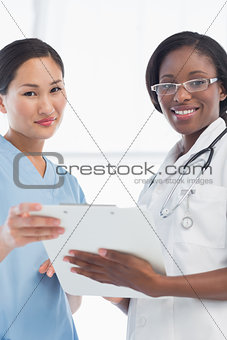 Female doctor and surgeon with report