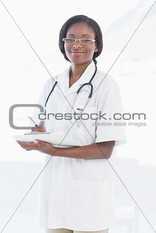 Portrait of a smiling female doctor with report