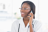 Smiling female doctor using mobile phone