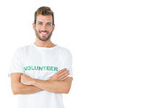 Portrait of a happy male volunteer standing with hands crossed