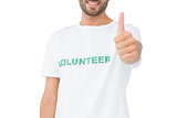Closeup of a happy male volunteer gesturing thumbs up