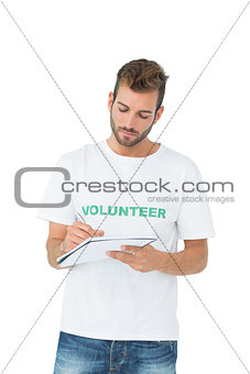 Young male volunteer writing a note