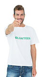 Portrait of a happy male volunteer pointing at you