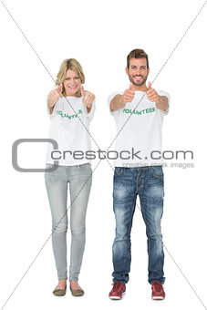 Portrait of two volunteers gesturing thumbs up