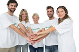 Group portrait of happy volunteers with hands together