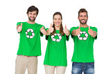 People in recycling symbol tshirts gesturing thumbs up
