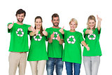 People in recycling symbol tshirts gesturing thumbs up