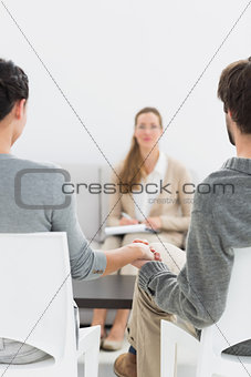 Blurred female financial adviser in meeting with couple