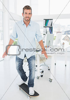 Happy young man skateboarding in creative office