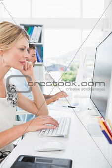 Casual young couple working on computers