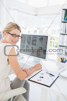 Side view portrait of a female photo editor working on computer