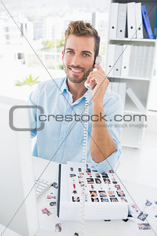 Portrait of a male photo editor using phone