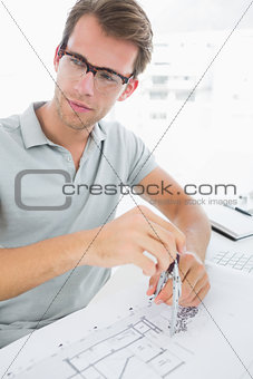 Man using compass on design