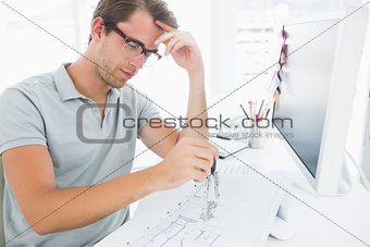 Man using compass on design