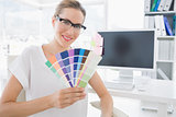 Female photo editor holding colors in office