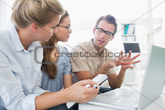 Three young people working on computer