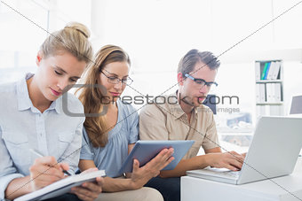 Concentrated three young people in office