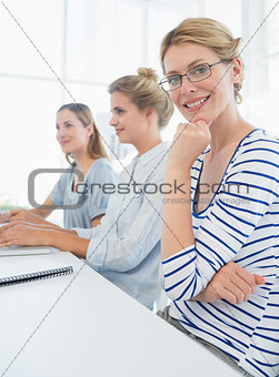 Three young people working in office