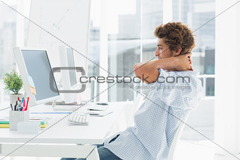 Casual business man using computer in bright office