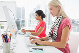Casual young women using computers in office