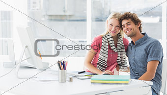 Smiling casual business couple in a bright office