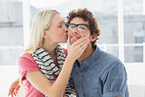 Woman kissing man on his cheek