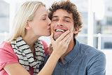 Woman kissing man on his cheek