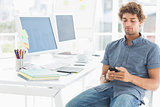 Man text messaging in a bright office
