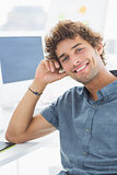 Smiling casual young man in office