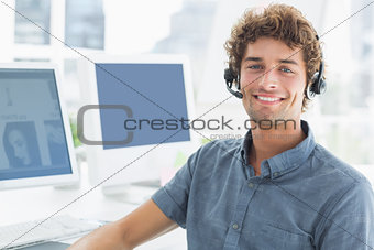 Smiling casual man with headset in the office