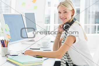Casual woman with headset using computer in office
