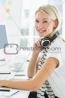 Portrait of of a woman with headset sitting in office