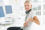 Casual woman with headset at computer desk in office
