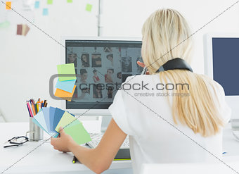 Rear view of a casual woman using computer in office