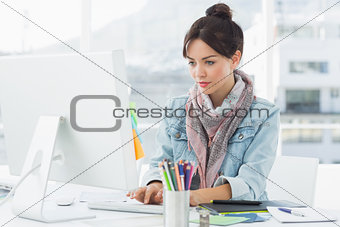 Casual woman using computer in office