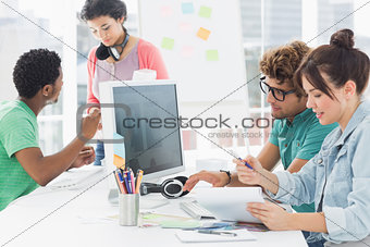 Artists working at desk in creative office