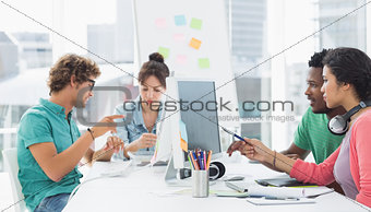 Artists working at desk in creative office