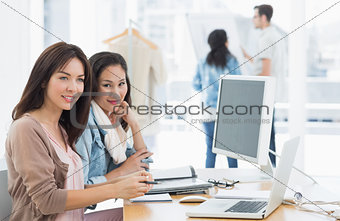 Female artists working at desk in creative office