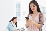 Woman text messaging in office